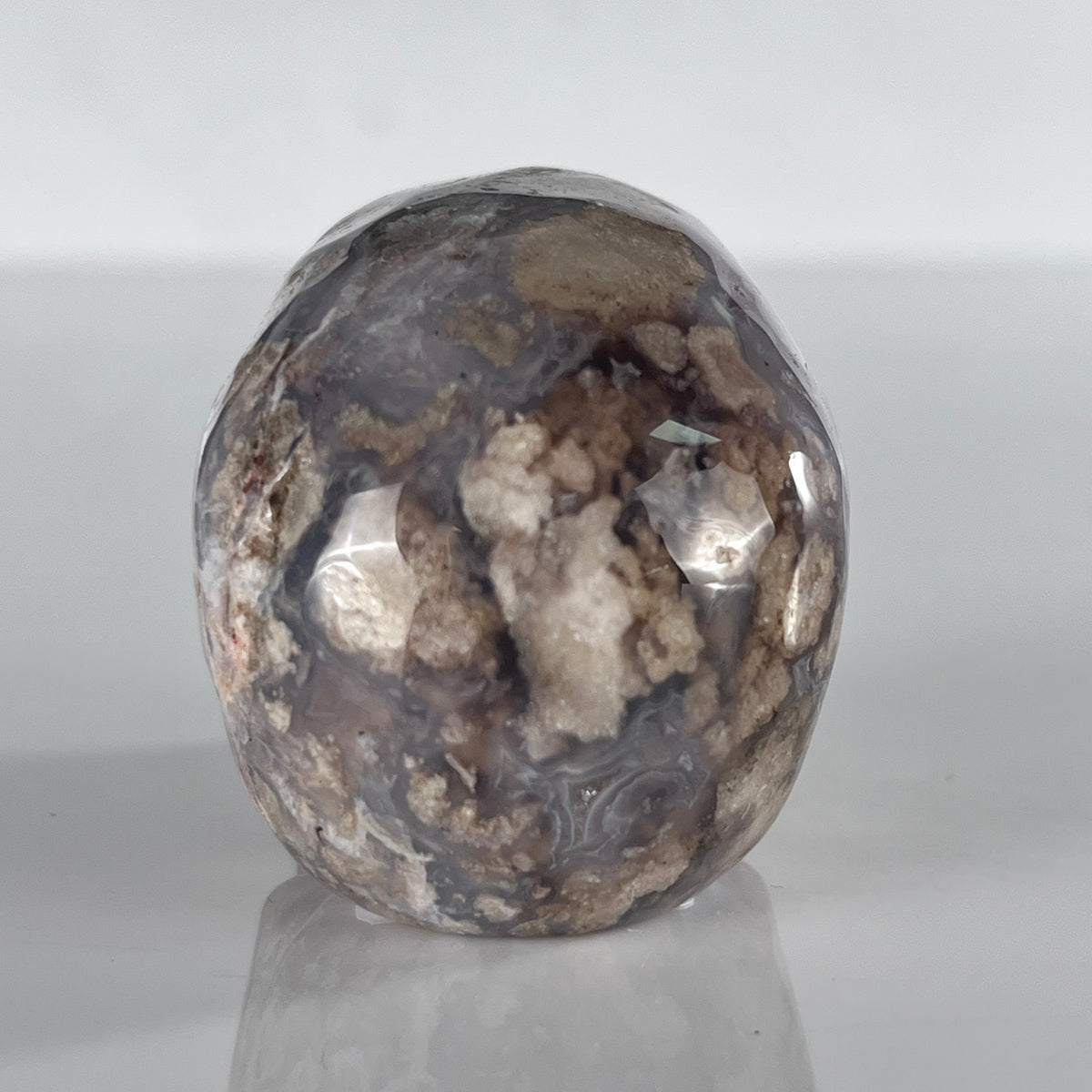 Back view of a 2-inch Blue Flower Agate human skull carving