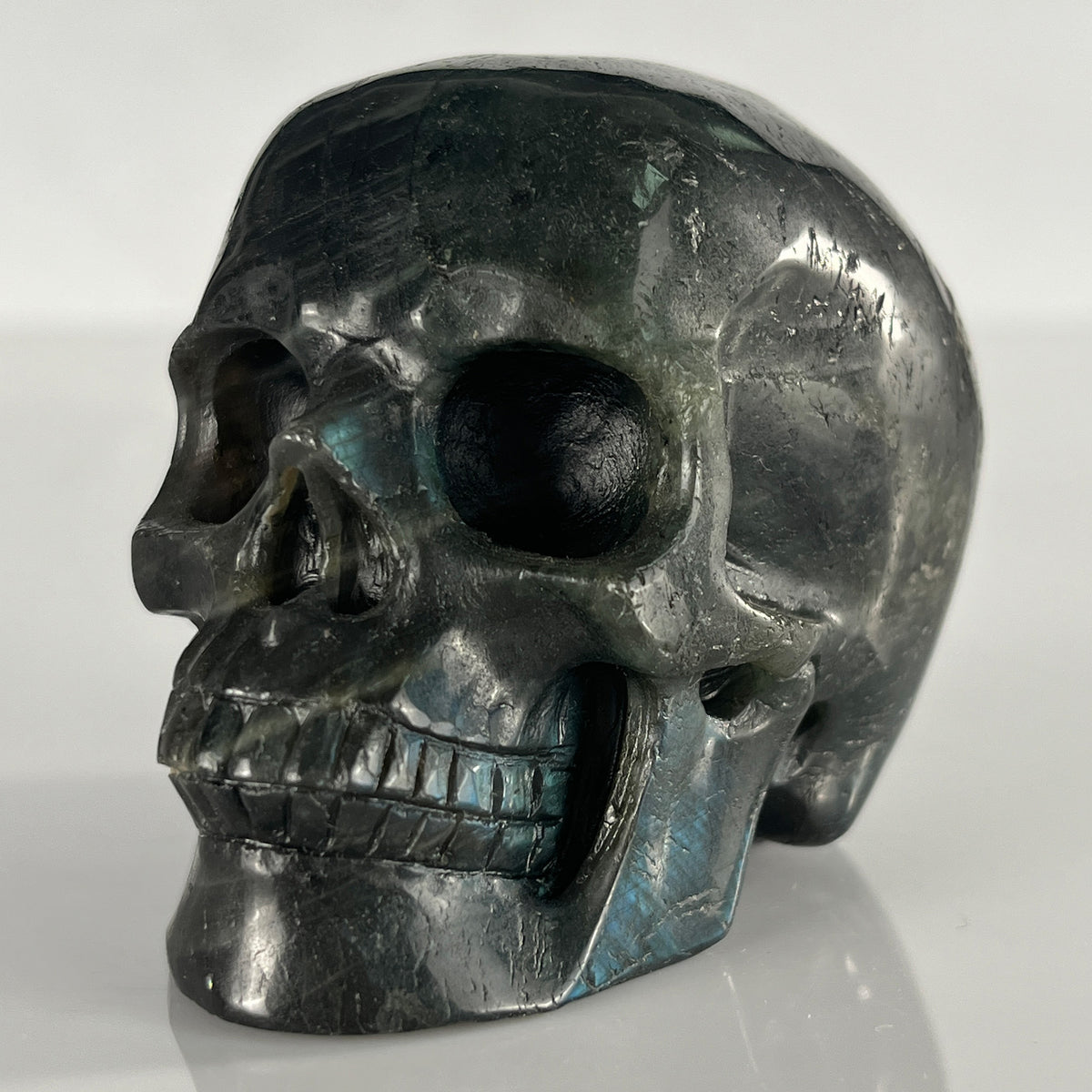 Left-front view of a 3-inch Blue Labradorite human skull carving