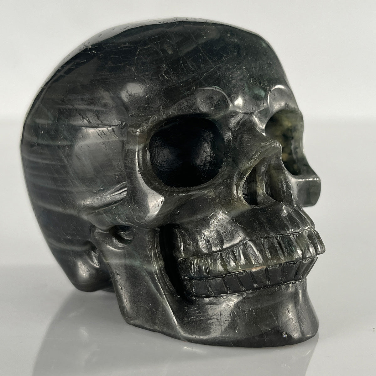 Right-front view of a 3-inch Blue Labradorite human skull carving