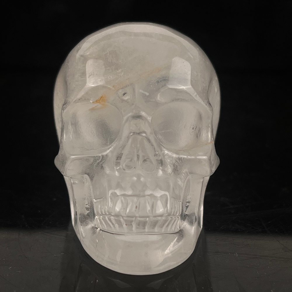 Front view of a 2-inch Clear Quartz human skull carving