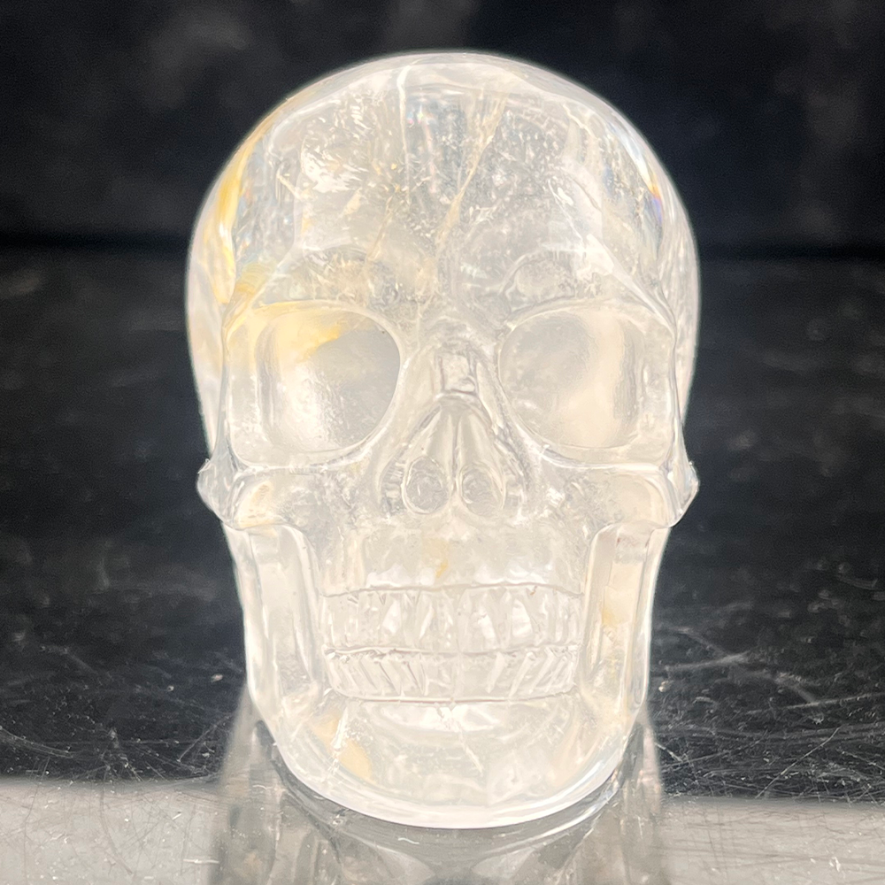 Front view of a 2-inch Clear Quartz human skull carving