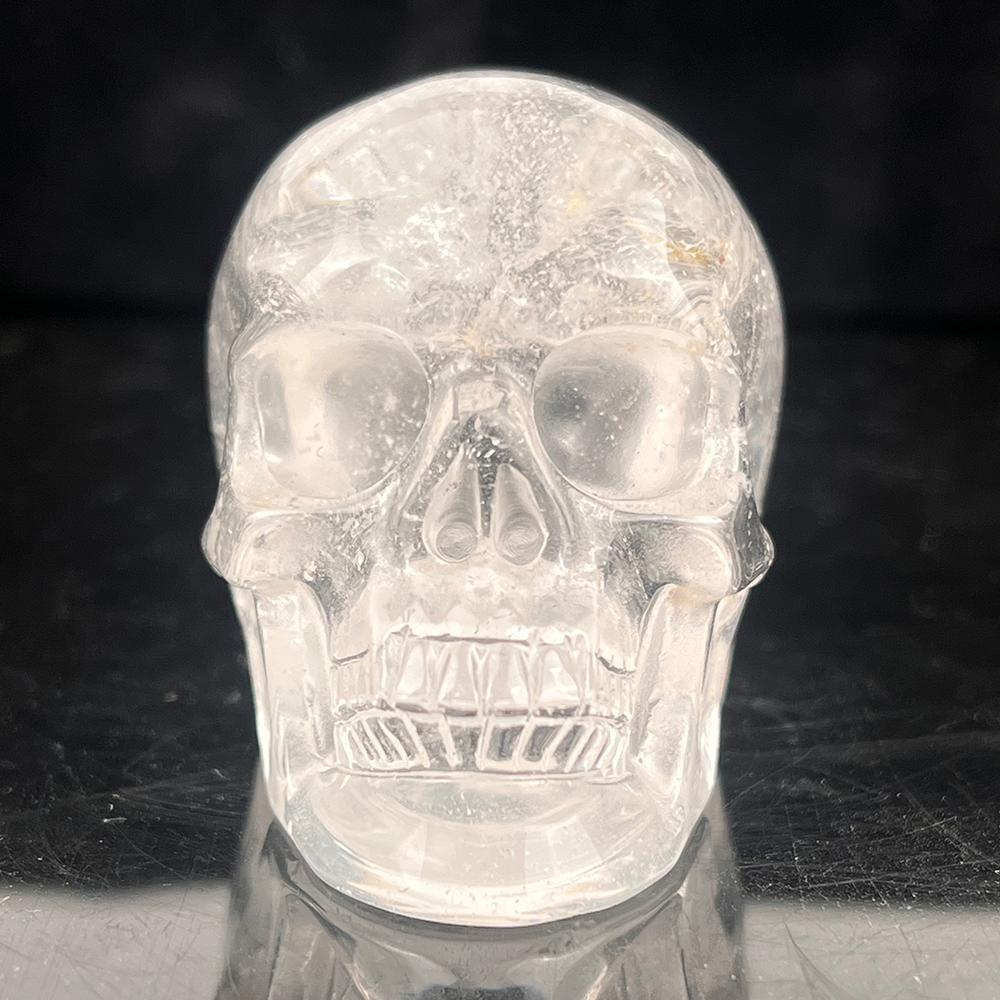Front view of a 2-inch Clear Quartz human skull carving
