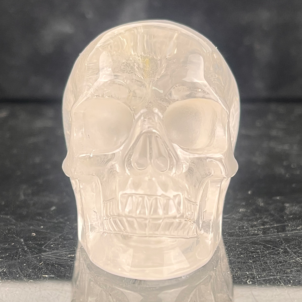 Front view of a 2-inch Clear Quartz human skull carving