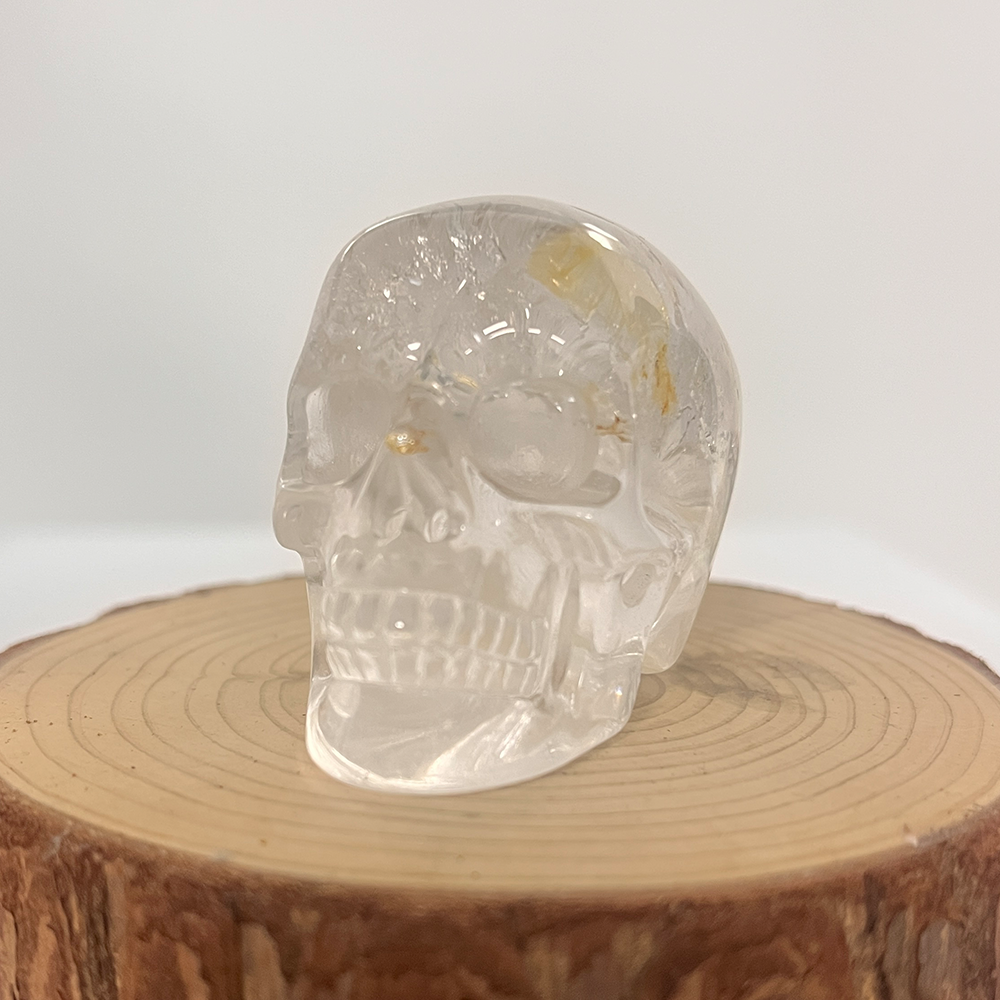 Front view of a 2-inch Clear Quartz human skull carving
