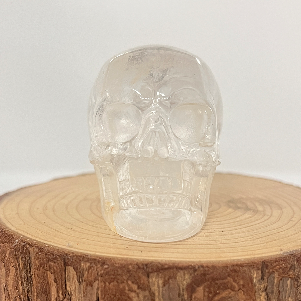 Front view of a 2-inch Clear Quartz human skull carving