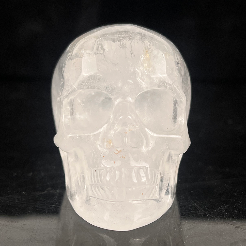 Front view of a 2-inch Clear Quartz human skull carving