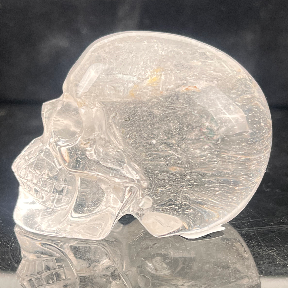 Left view of a 2-inch Clear Quartz human skull carving