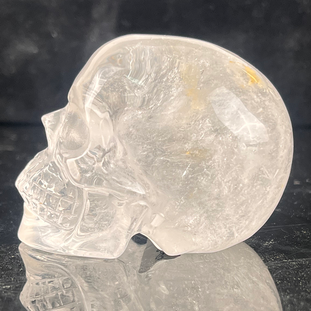 Left view of a 2-inch Clear Quartz human skull carving