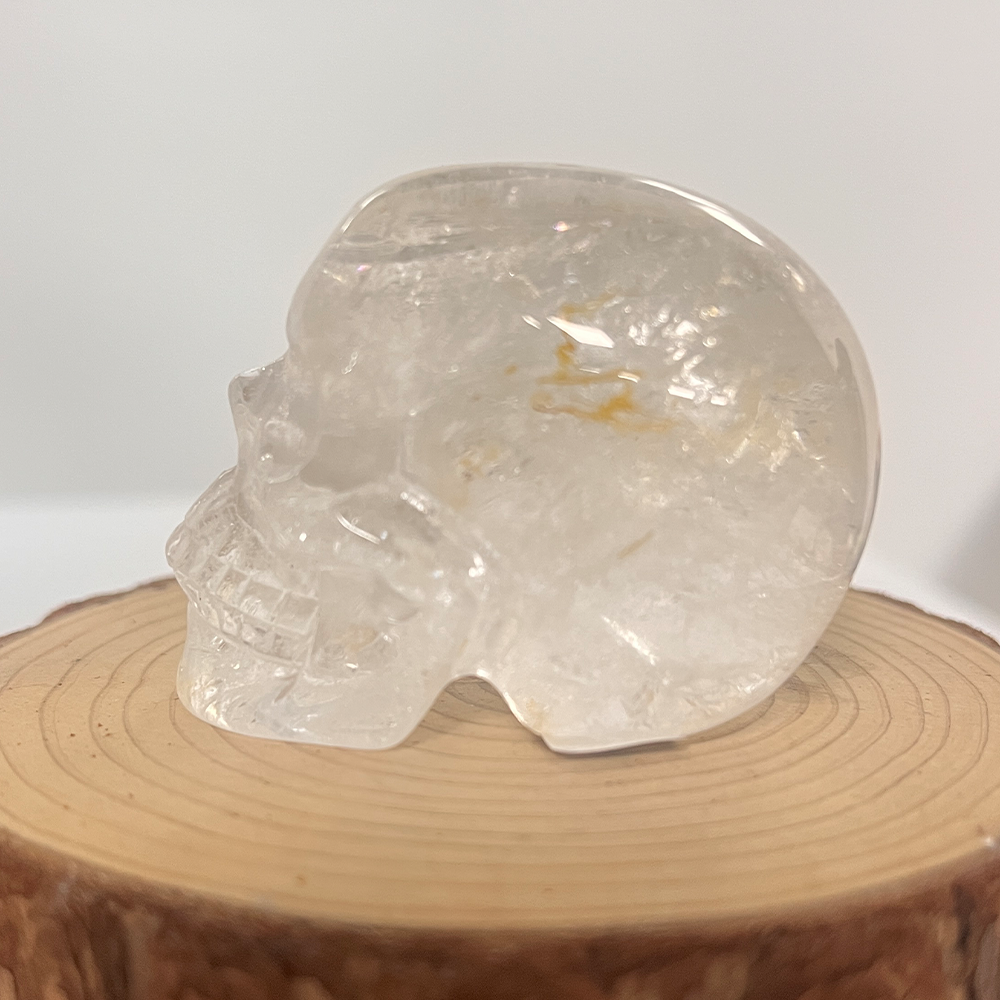 Left view of a 2-inch Clear Quartz human skull carving