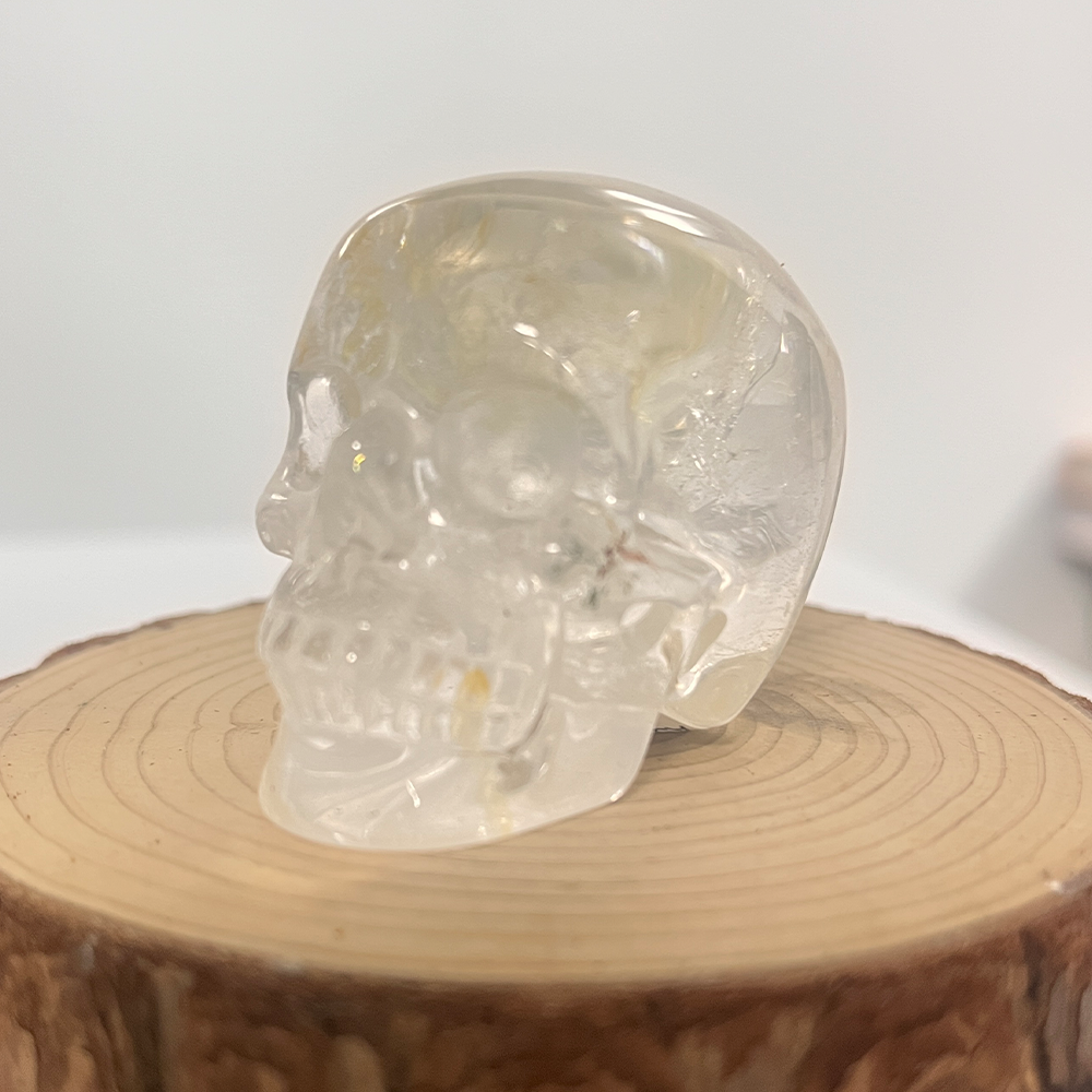 Left-front view of a 2-inch Clear Quartz human skull carving