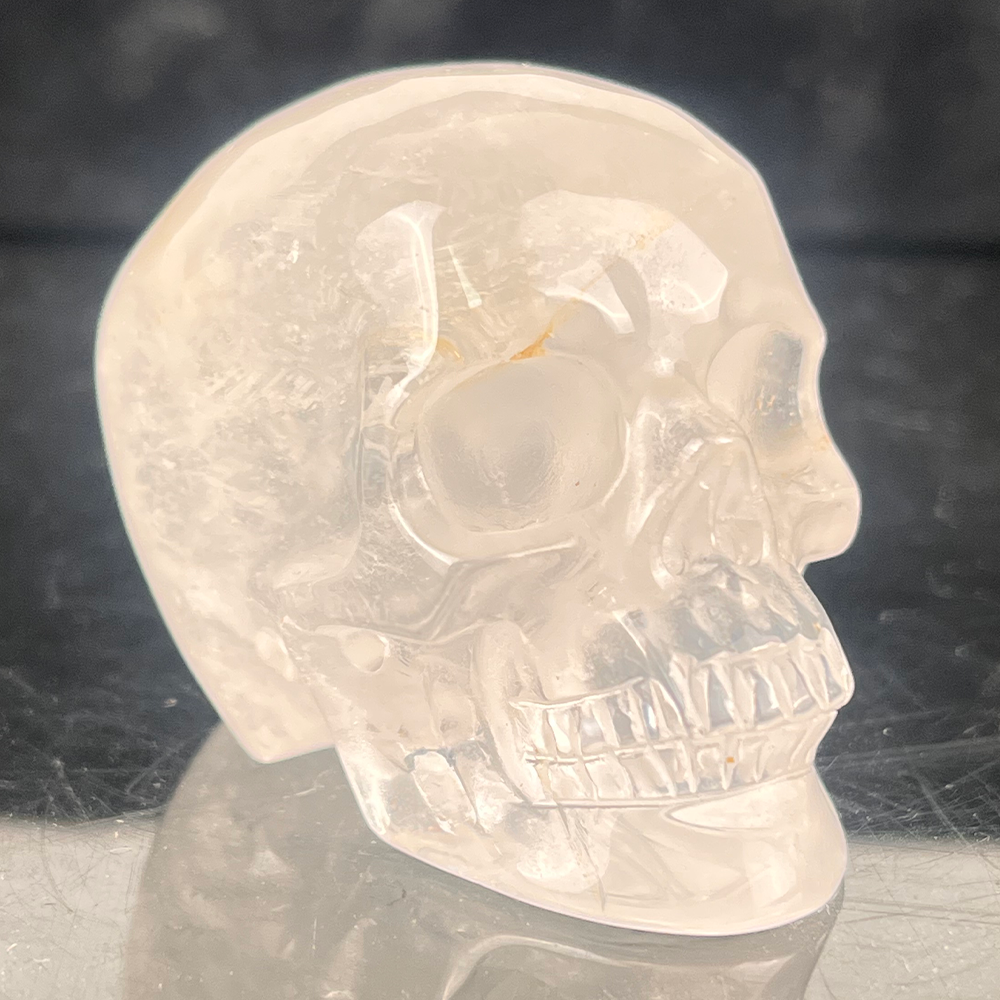 Right-front view of a 2-inch Clear Quartz human skull carving