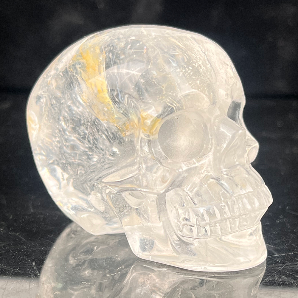 Right-front view of a 2-inch Clear Quartz human skull carving