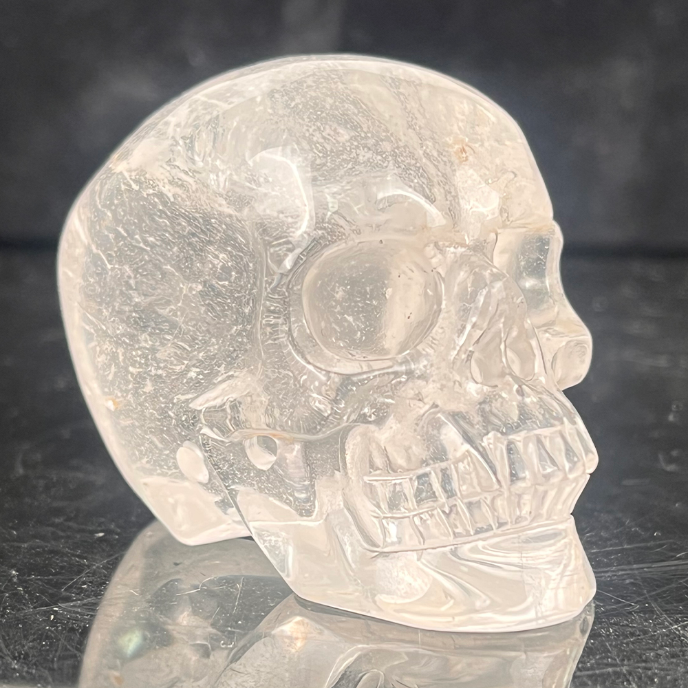 Right-front view of a 2-inch Clear Quartz human skull carving
