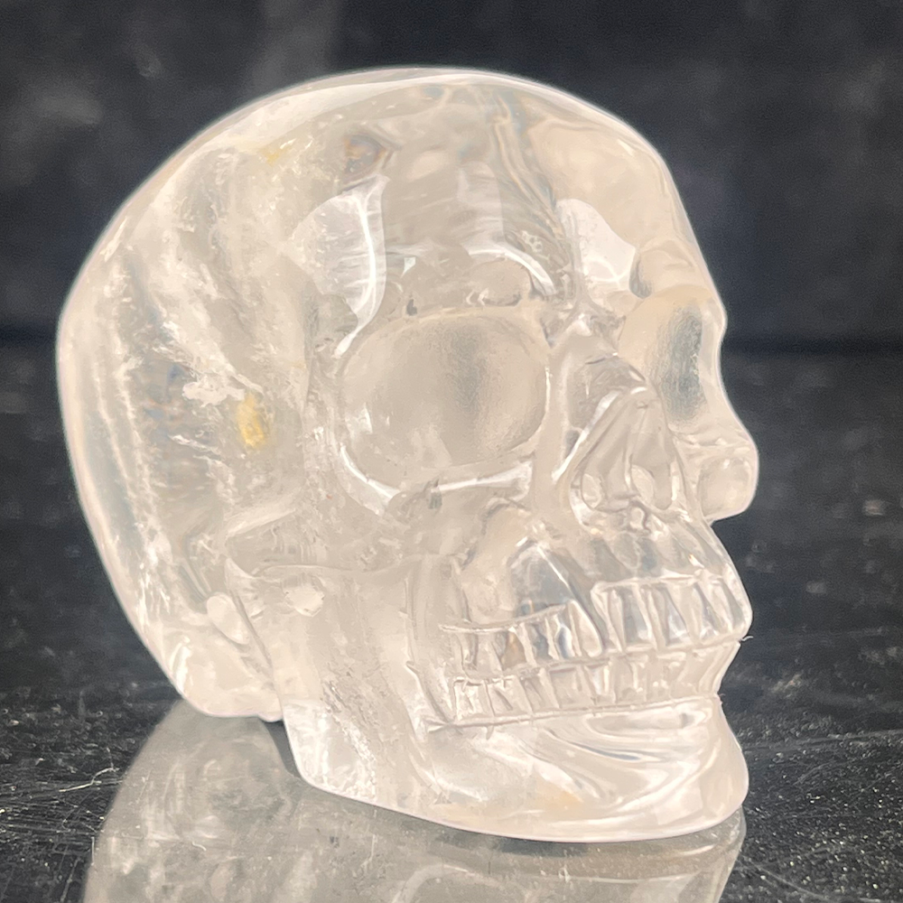 Right-front view of a 2-inch Clear Quartz human skull carving