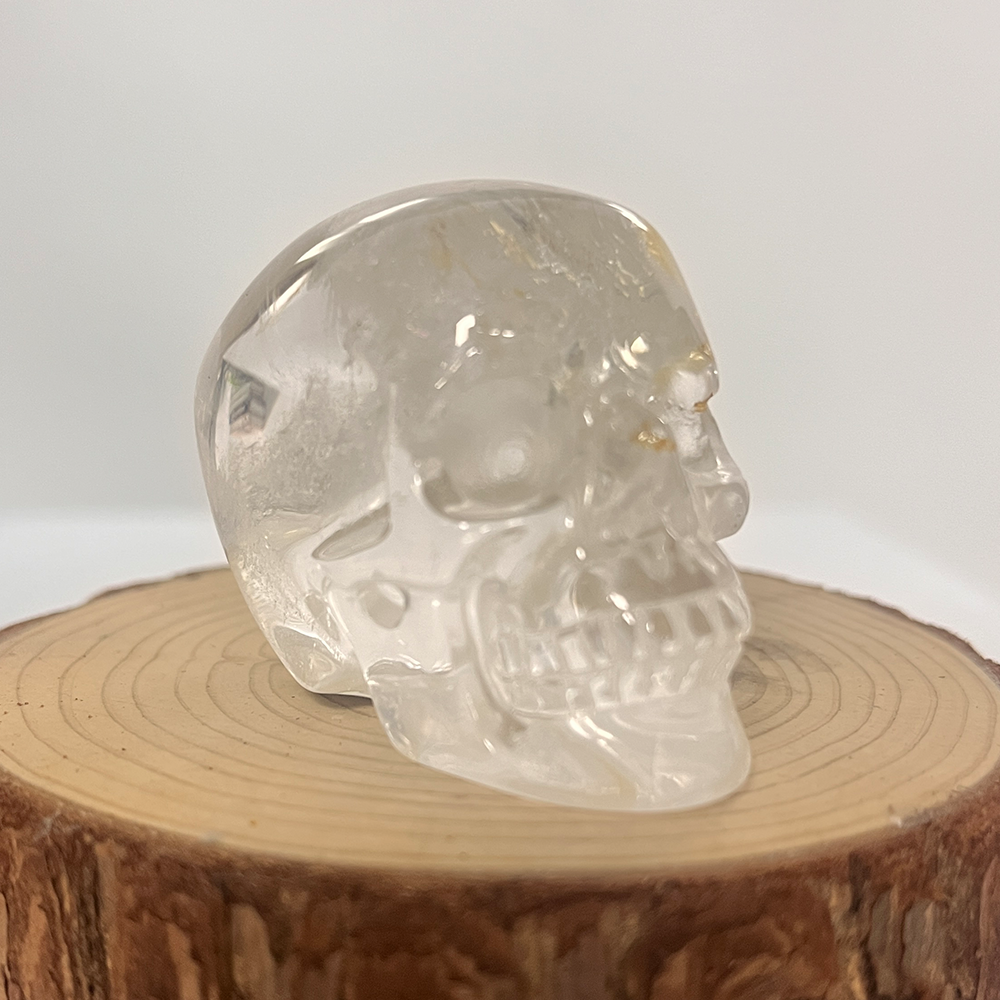 Right-front view of a 2-inch Clear Quartz human skull carving