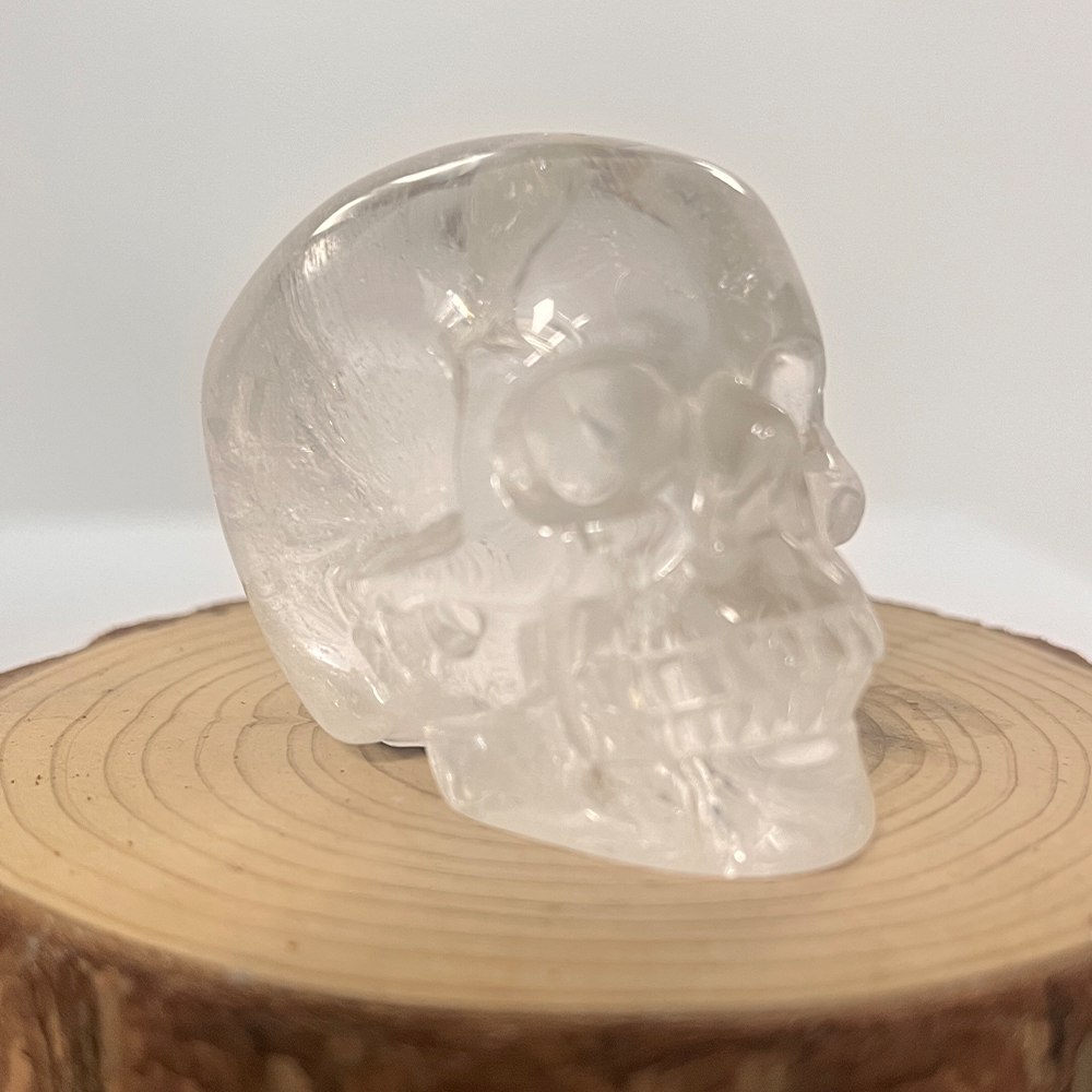Right-front view of a 2-inch Clear Quartz human skull carving