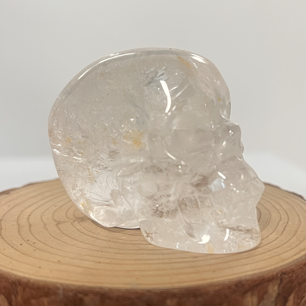 Right-front view of a 2-inch Clear Quartz human skull carving
