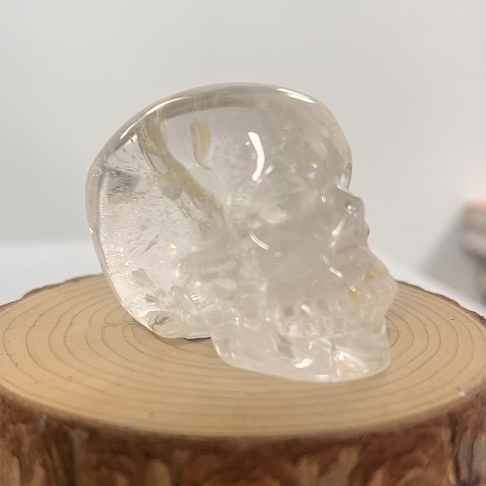Right-front view of a 2-inch Clear Quartz human skull carving