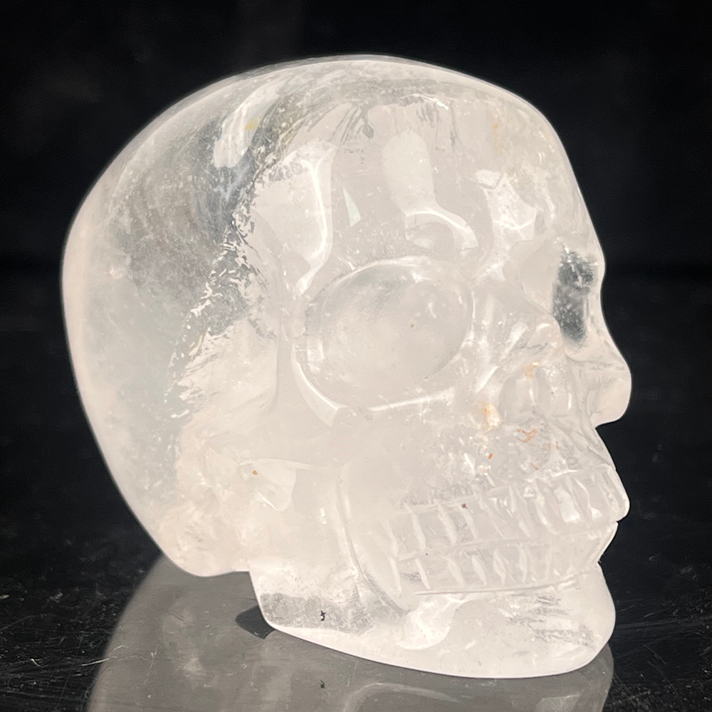 Right-front view of a 2-inch Clear Quartz human skull carving
