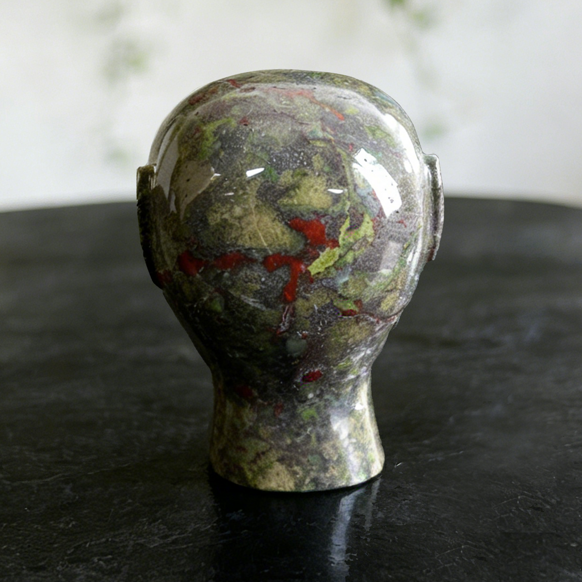 Additional view of a Dragon Bloodstone alien skull carving