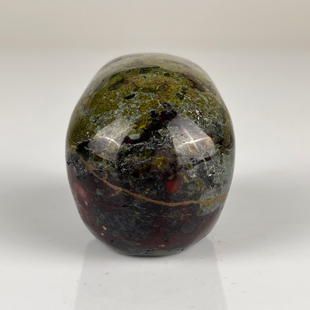 Back view of a 2-inch Dragon Bloodstone human skull carving