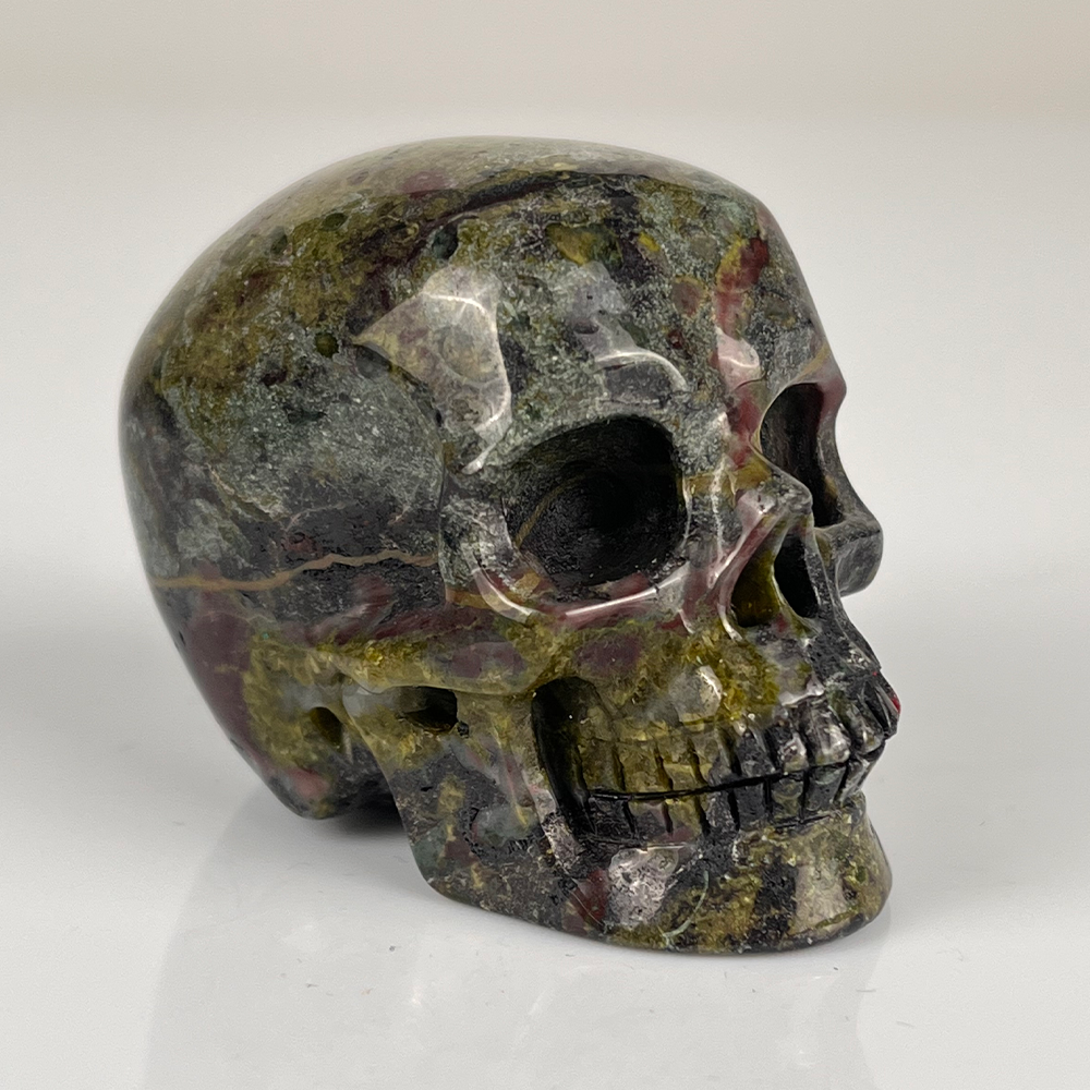 Right-front view of a 2-inch Dragon Bloodstone human skull carving