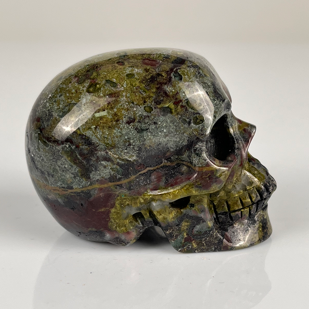 Right view of a 2-inch Dragon Bloodstone human skull carving