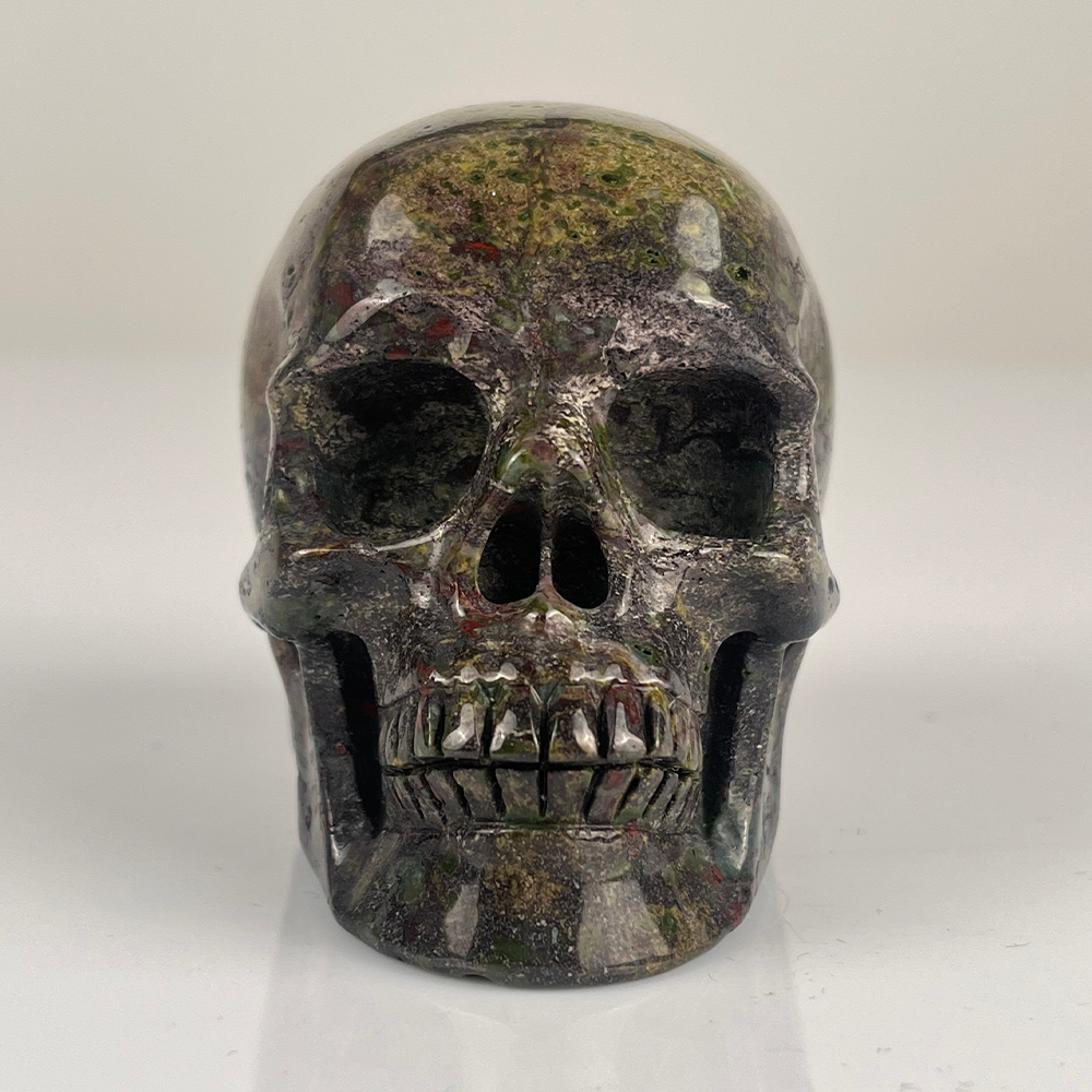 Front view of a 3-inch Dragon Bloodstone human skull carving