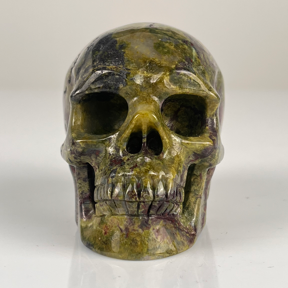 Front view of a 3-inch Dragon Bloodstone human skull carving