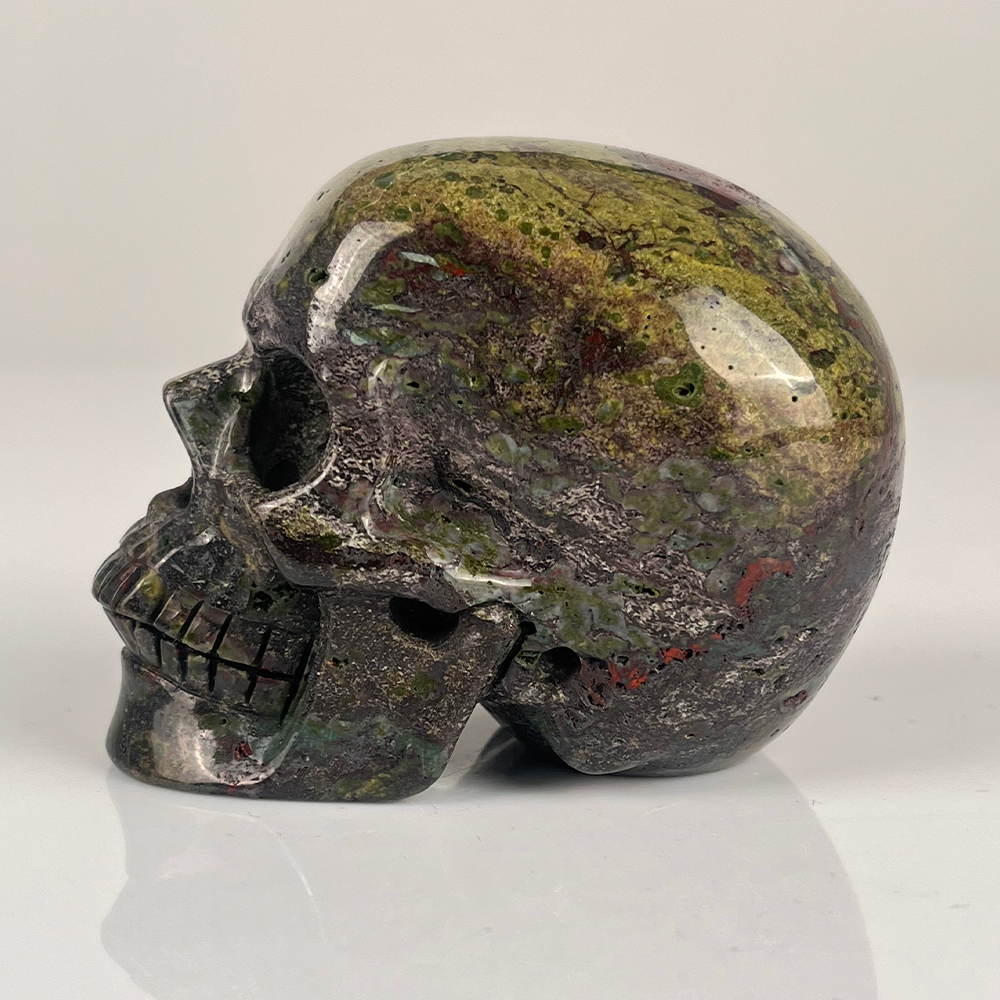 Left view of a 3-inch Dragon Bloodstone human skull carving