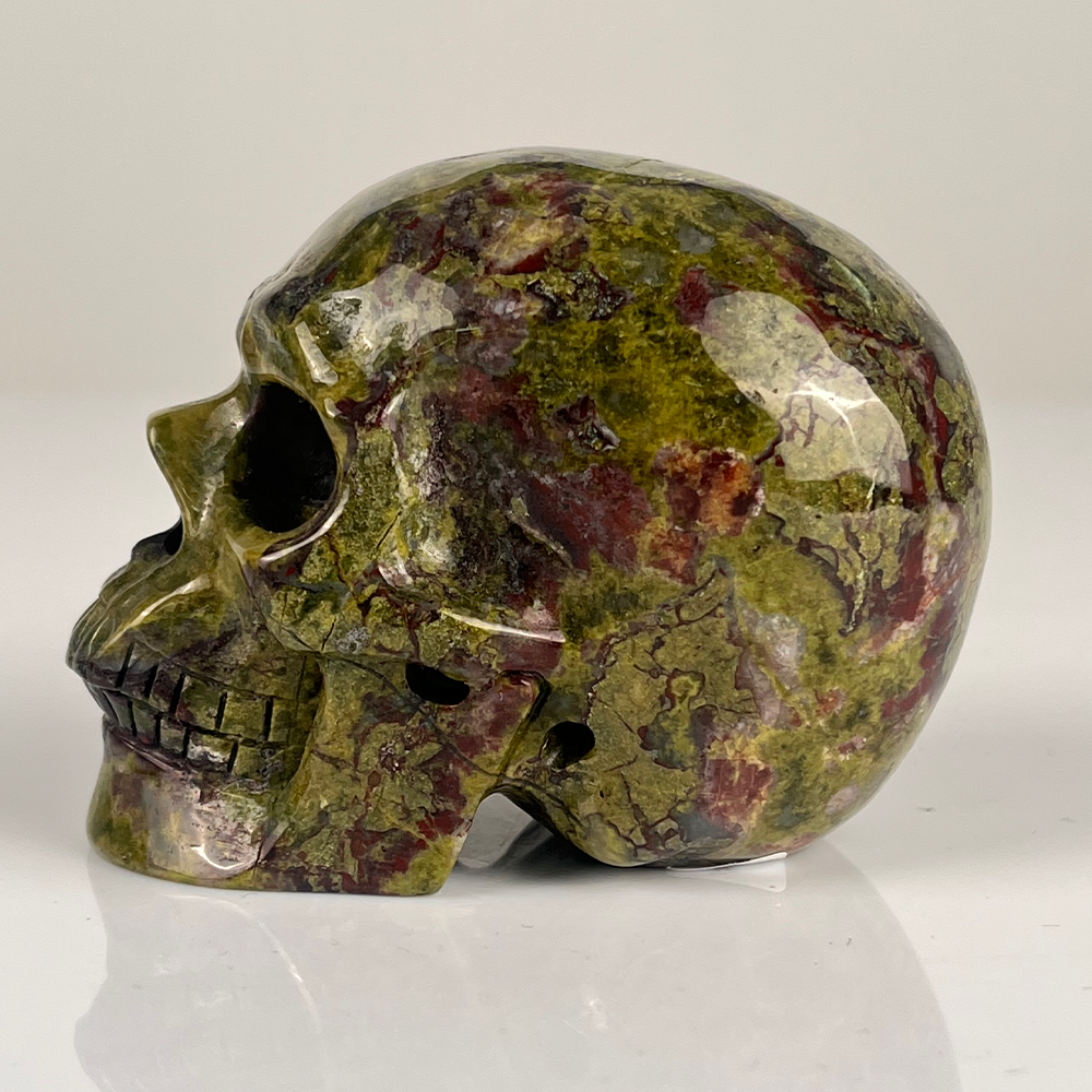 Left view of a 3-inch Dragon Bloodstone human skull carving