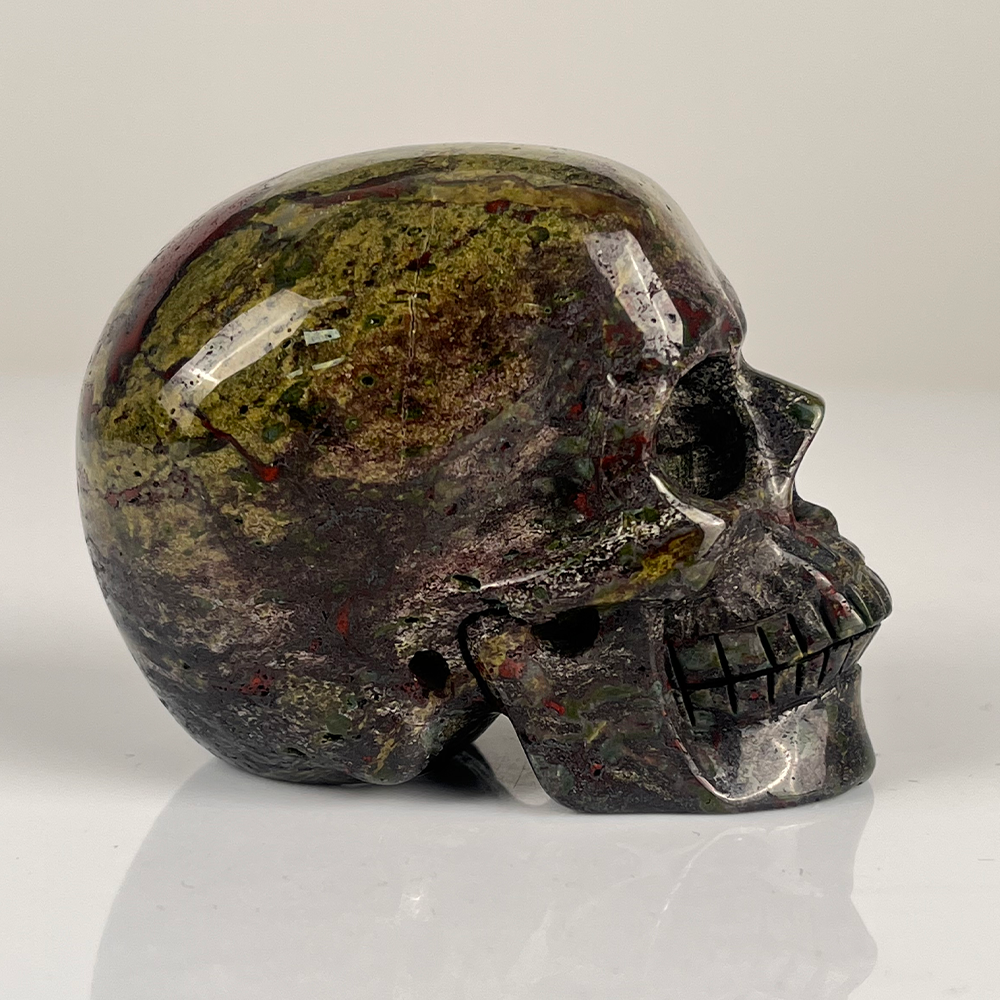 Right view of a 3-inch Dragon Bloodstone human skull carving