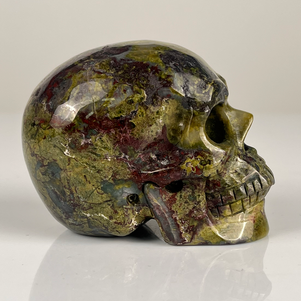 Right view of a 3-inch Dragon Bloodstone human skull carving
