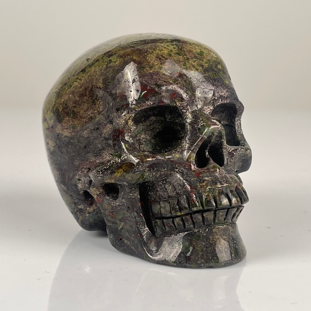 Right-front view of a 3-inch Dragon Bloodstone human skull carving