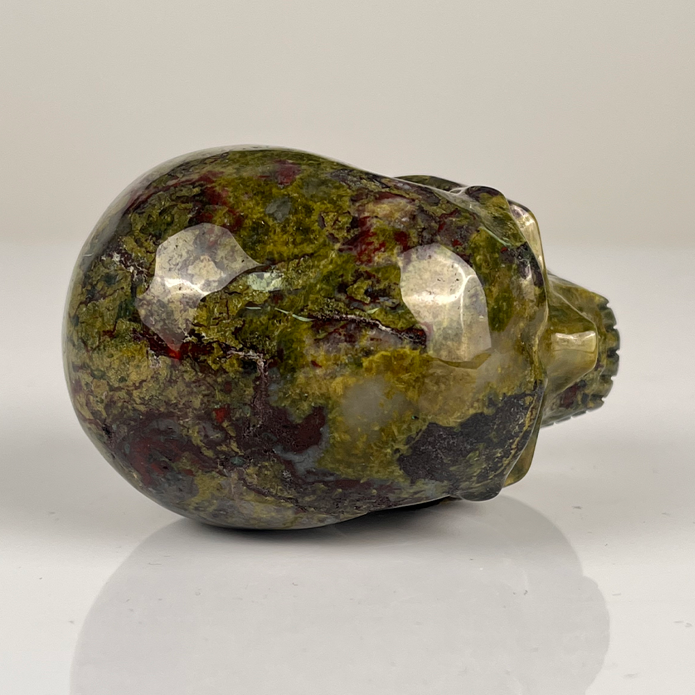 Top view of a 3-inch Dragon Bloodstone human skull carving