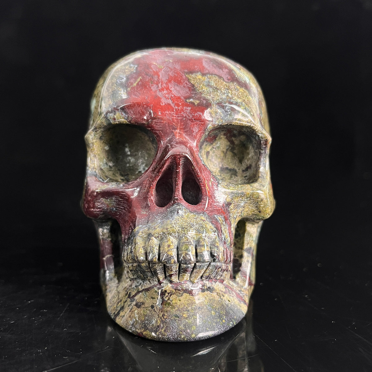 Front view of a 4.5-inch Dragon Bloodstone human skull carving