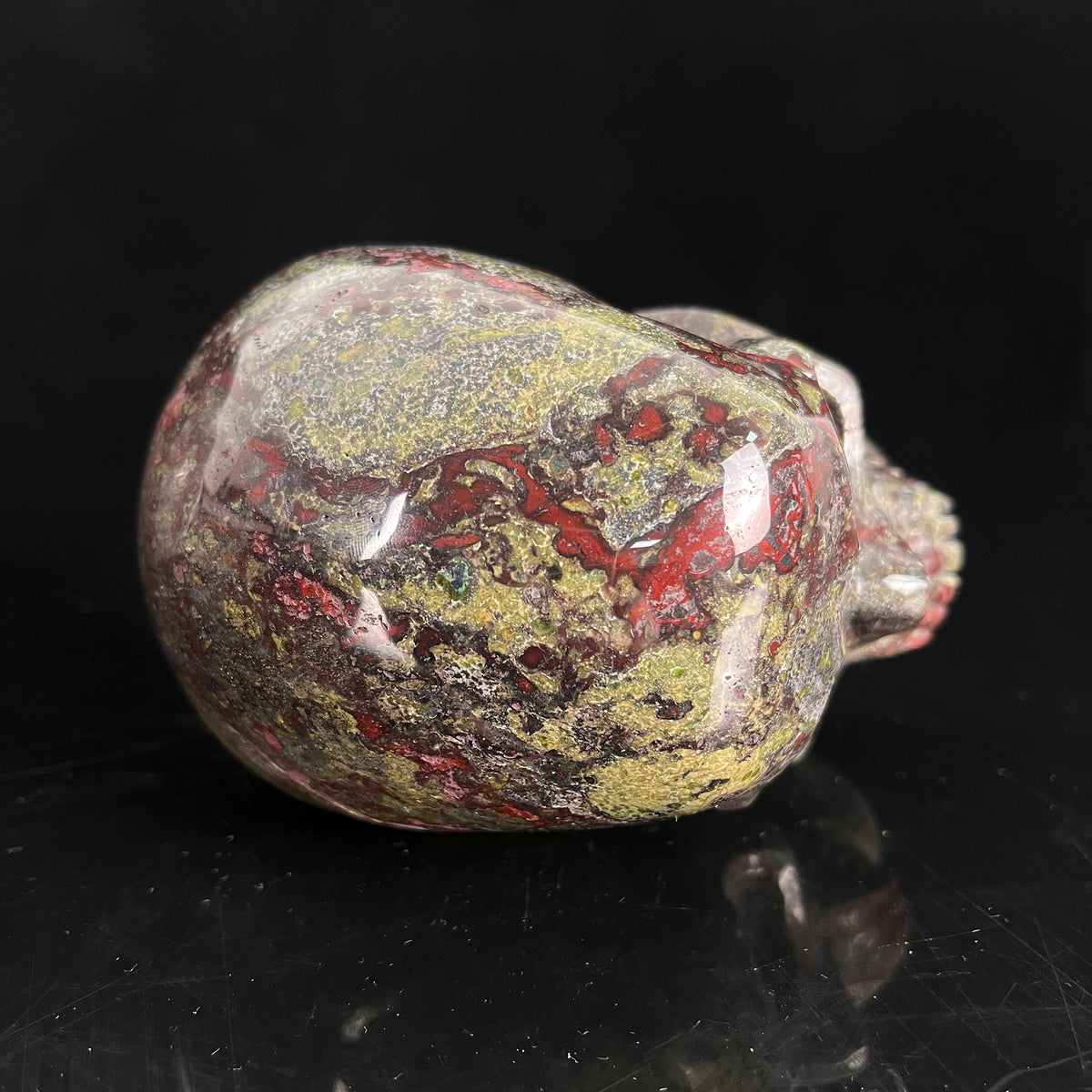 Top view of a 4.5-inch Dragon Bloodstone human skull carving