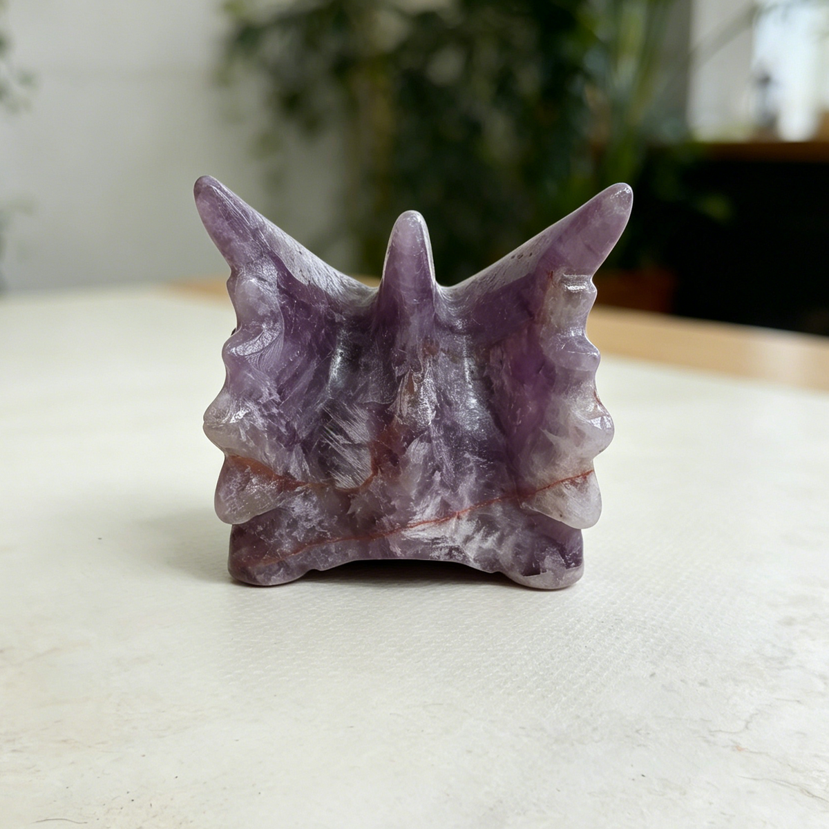 Additional view of a 3-inch Dream Amethyst dragon skull carving