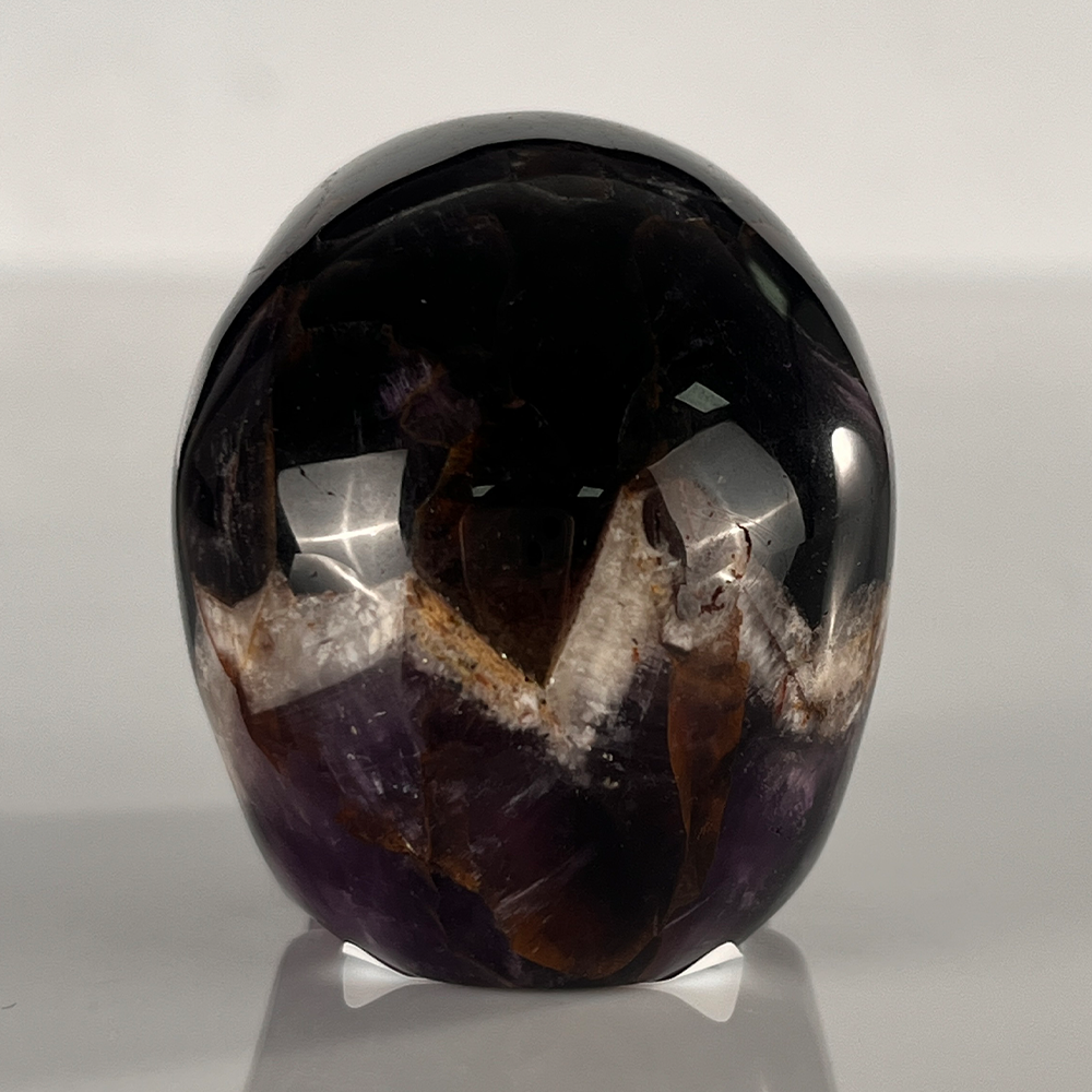 Back view of a 2-inch Dream Amethyst human skull carving
