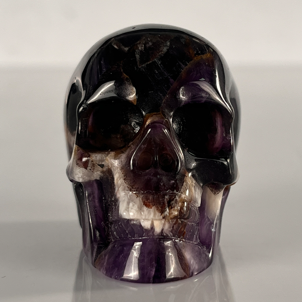 Front view of a 2-inch Dream Amethyst human skull carving