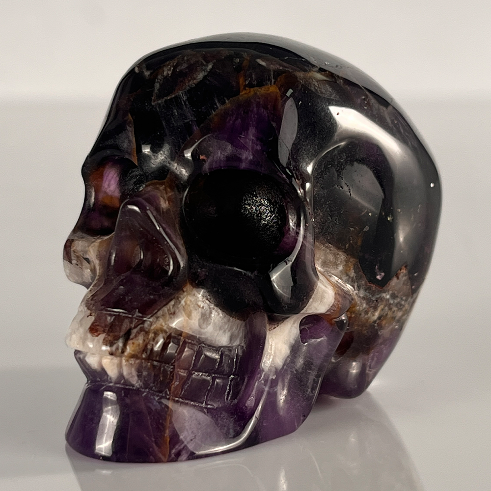 Left-front view of a 2-inch Dream Amethyst human skull carving