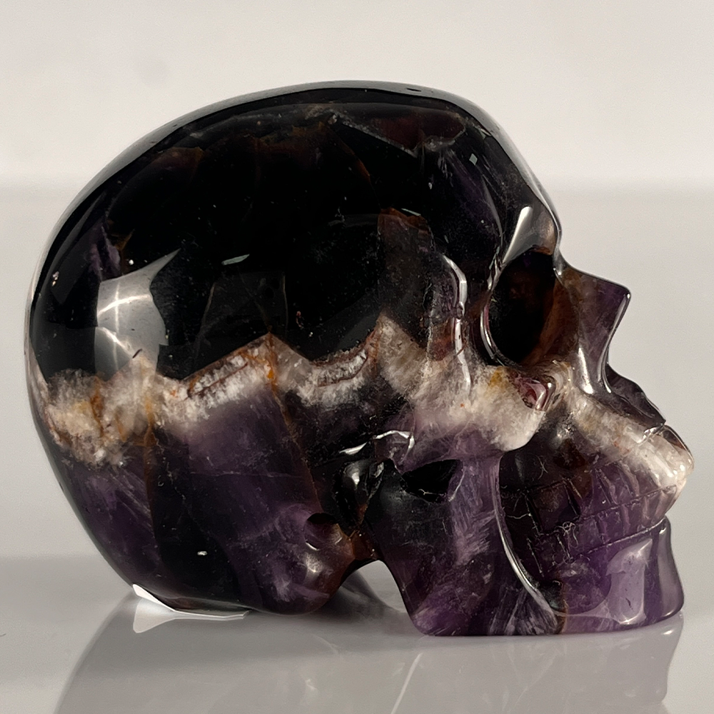 Right view of a 2-inch Dream Amethyst human skull carving