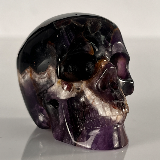 Right-front view of a 2-inch Dream Amethyst human skull carving