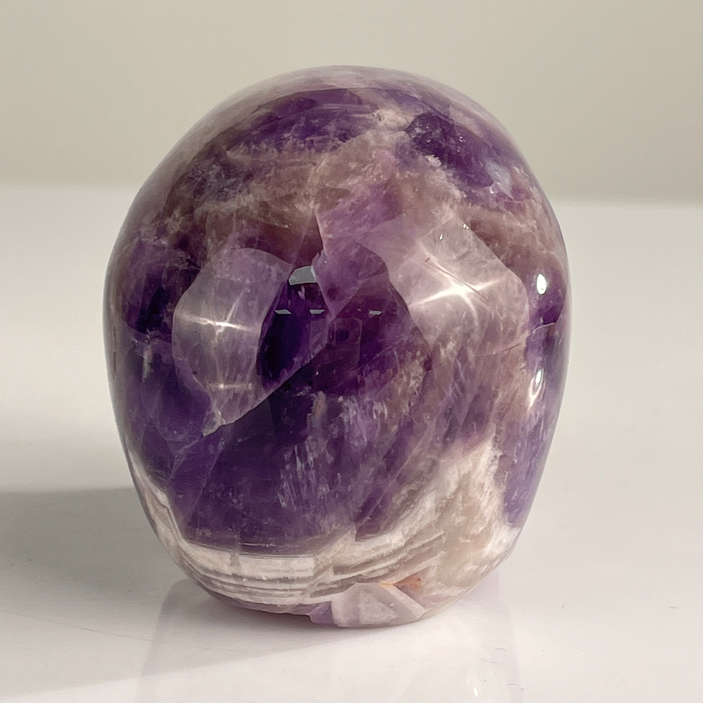 Back view of a 3-inch Dream Amethyst human skull carving