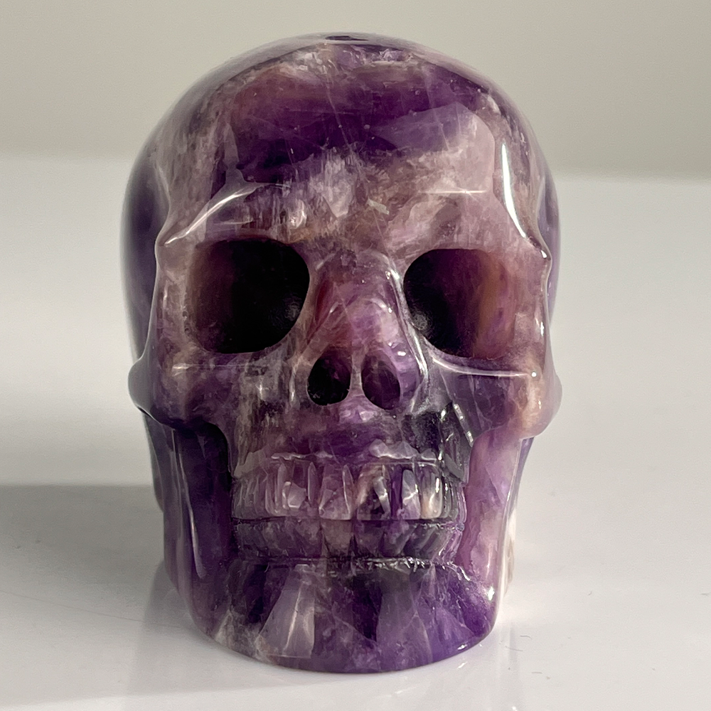 Front view of a 3-inch Dream Amethyst human skull carving