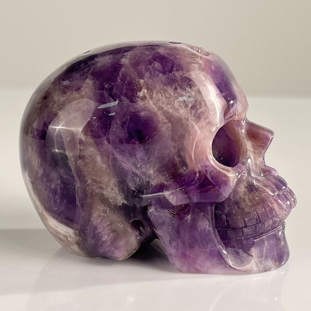 Right view of a 3-inch Dream Amethyst human skull carving