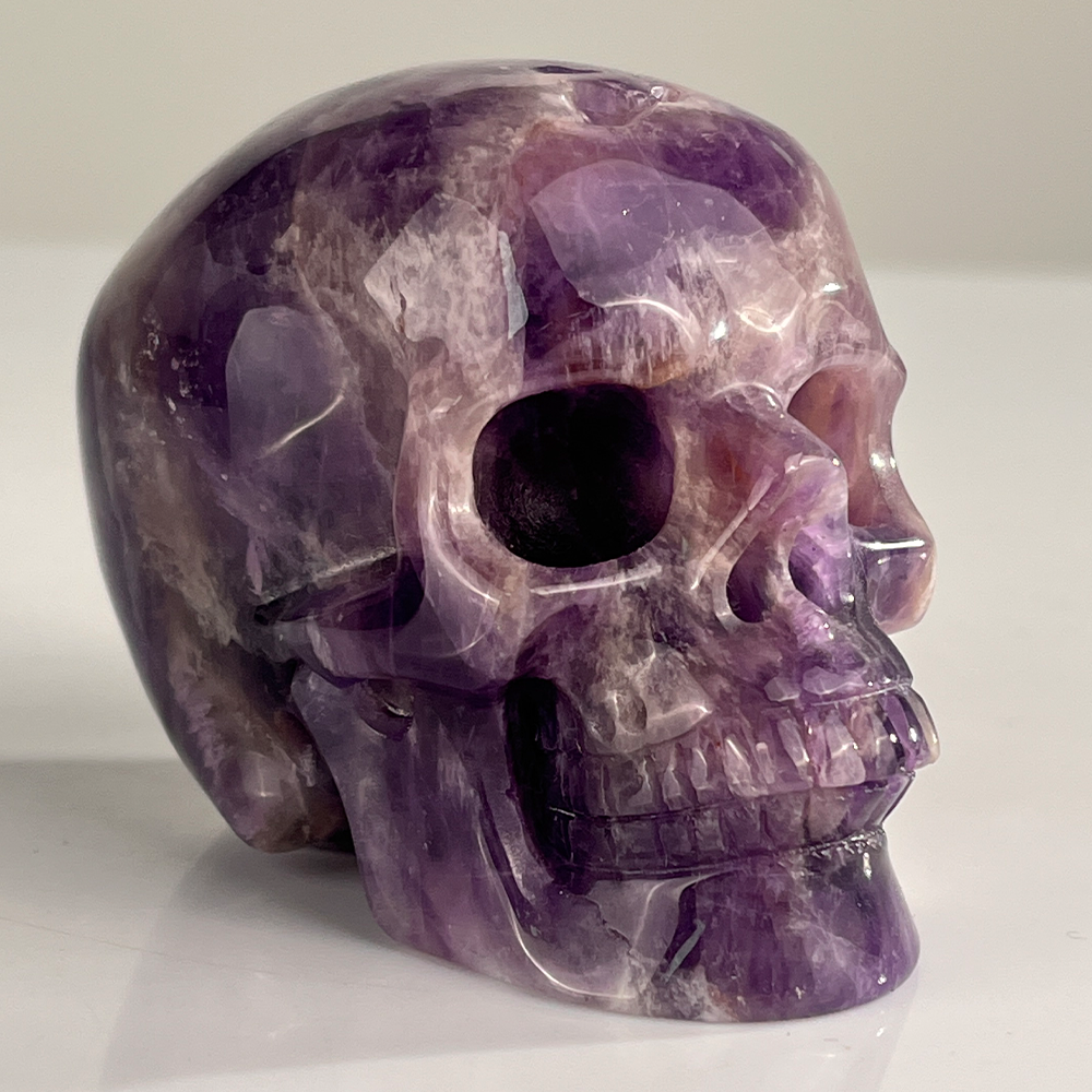 Right-front view of a 3-inch Dream Amethyst human skull carving