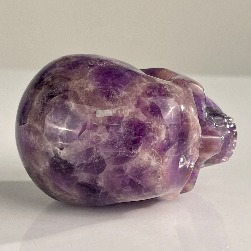 Top view of a 3-inch Dream Amethyst human skull carving