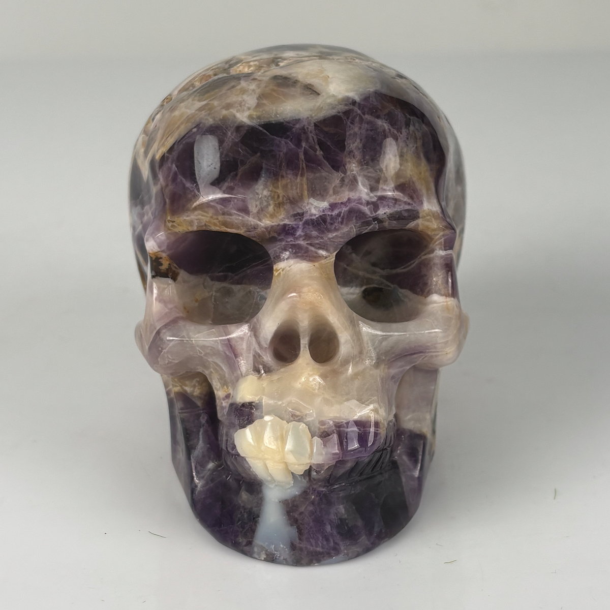 Front view of a 4.5-inch Dream Amethyst human skull carving