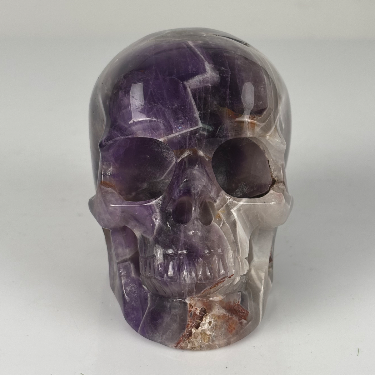 Front view of a 4.5-inch Dream Amethyst human skull carving